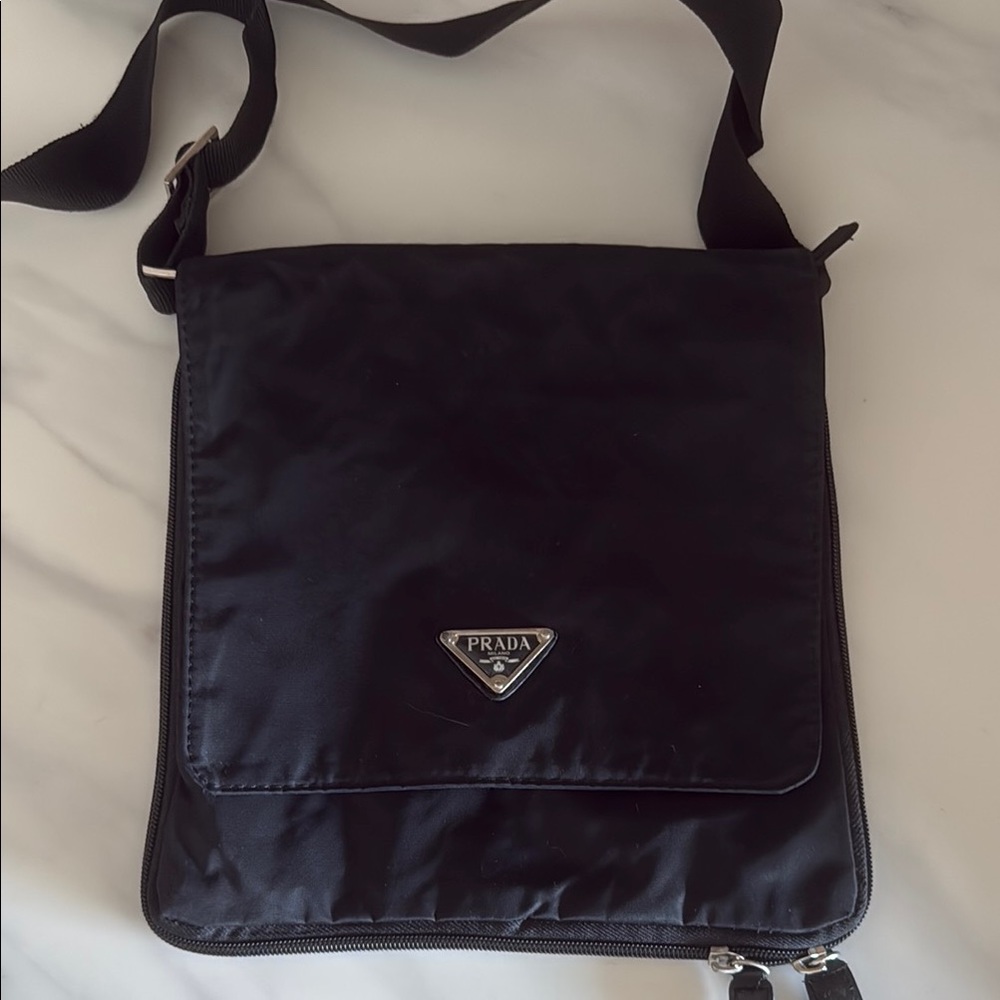 Black Messenger Bag with Silver Logo and Flap Closure